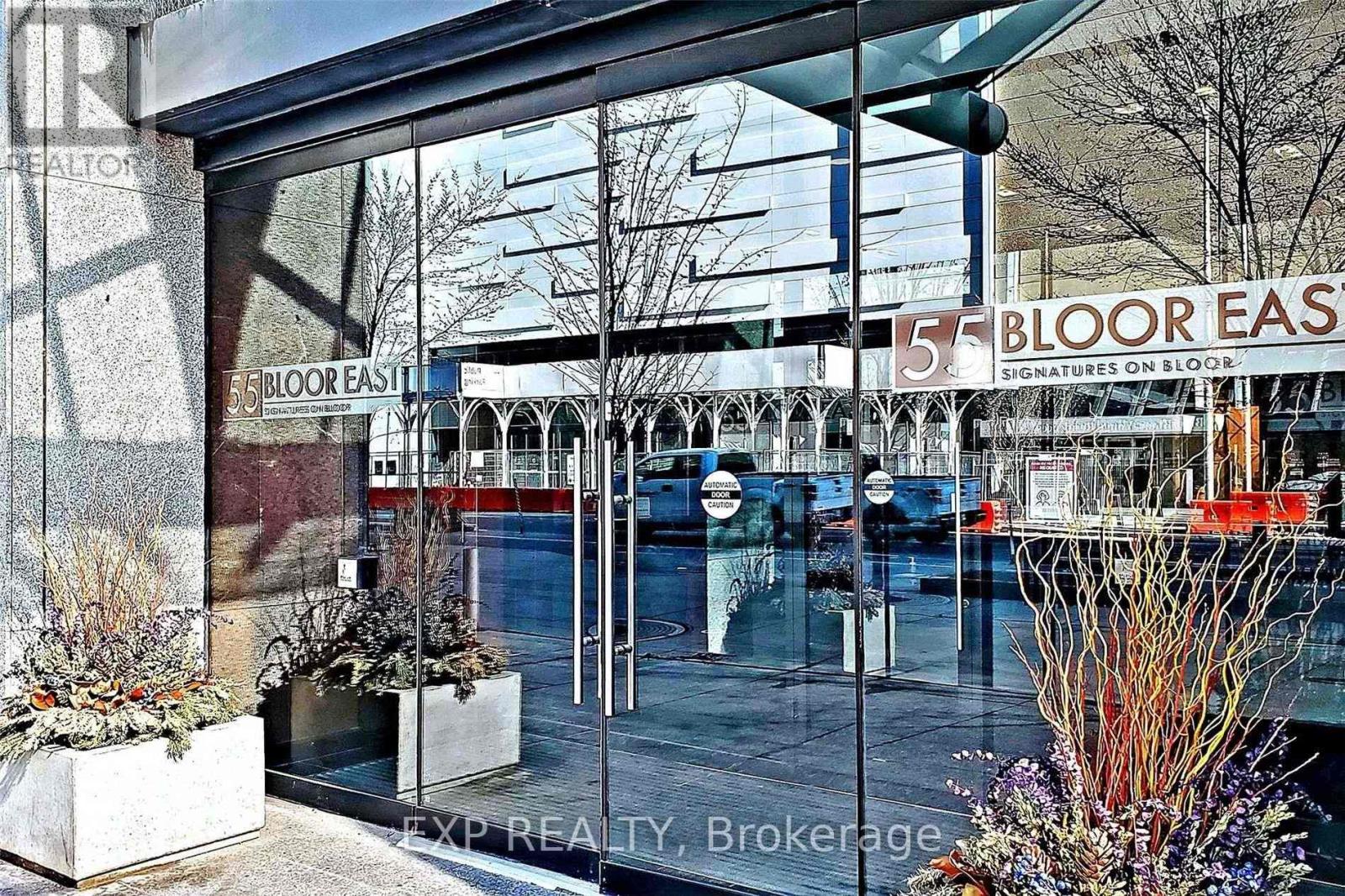 A glass door entrance to a building with a sign that says Bloor East.