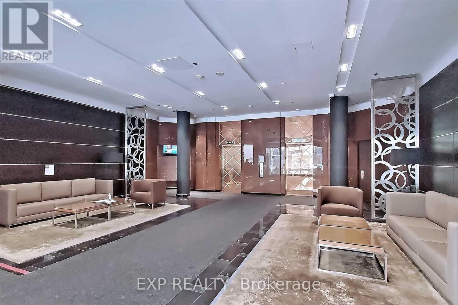 A spacious living room with a long couch and a coffee table in the center.