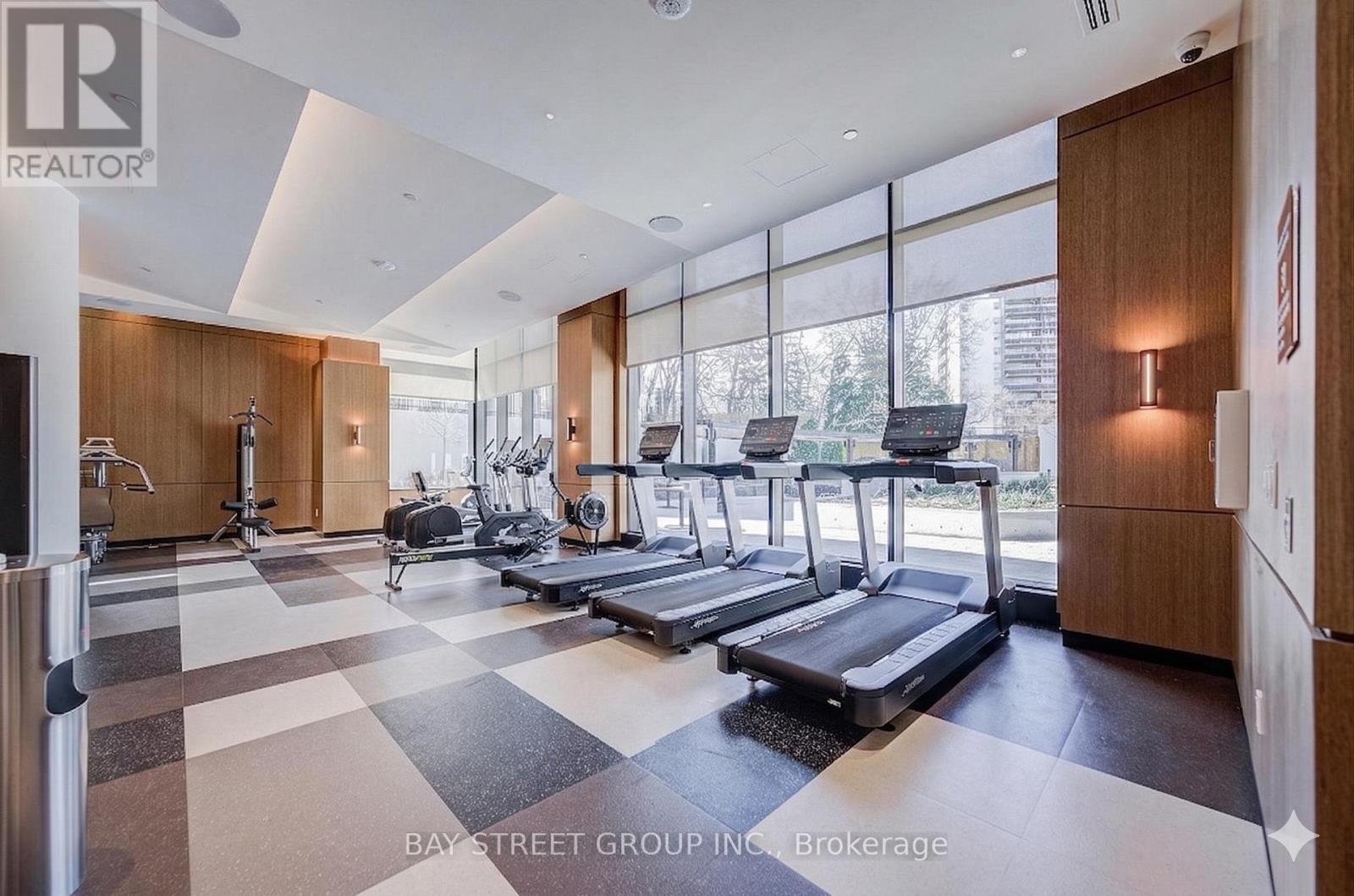A gym with treadmills, weights, and exercise equipment.