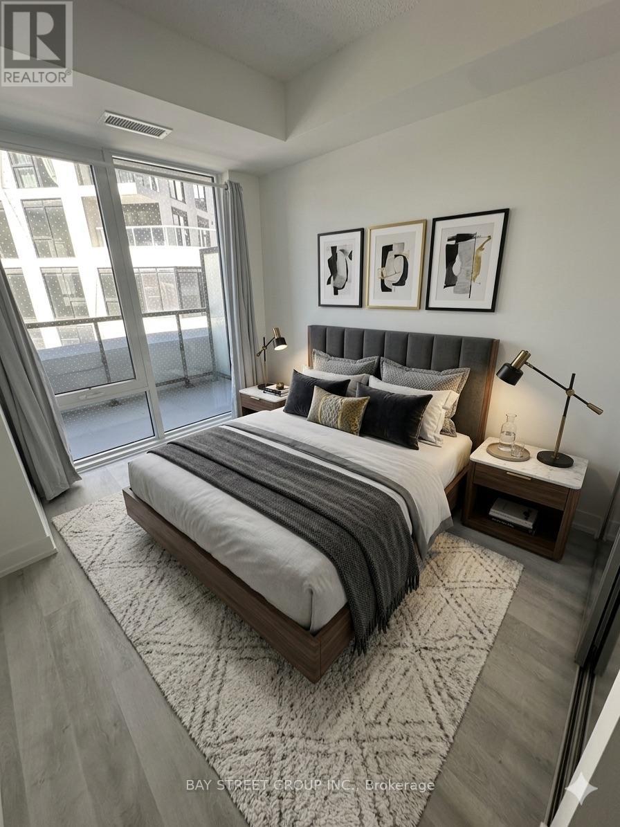 A bedroom with a large bed and a window overlooking a cityscape.