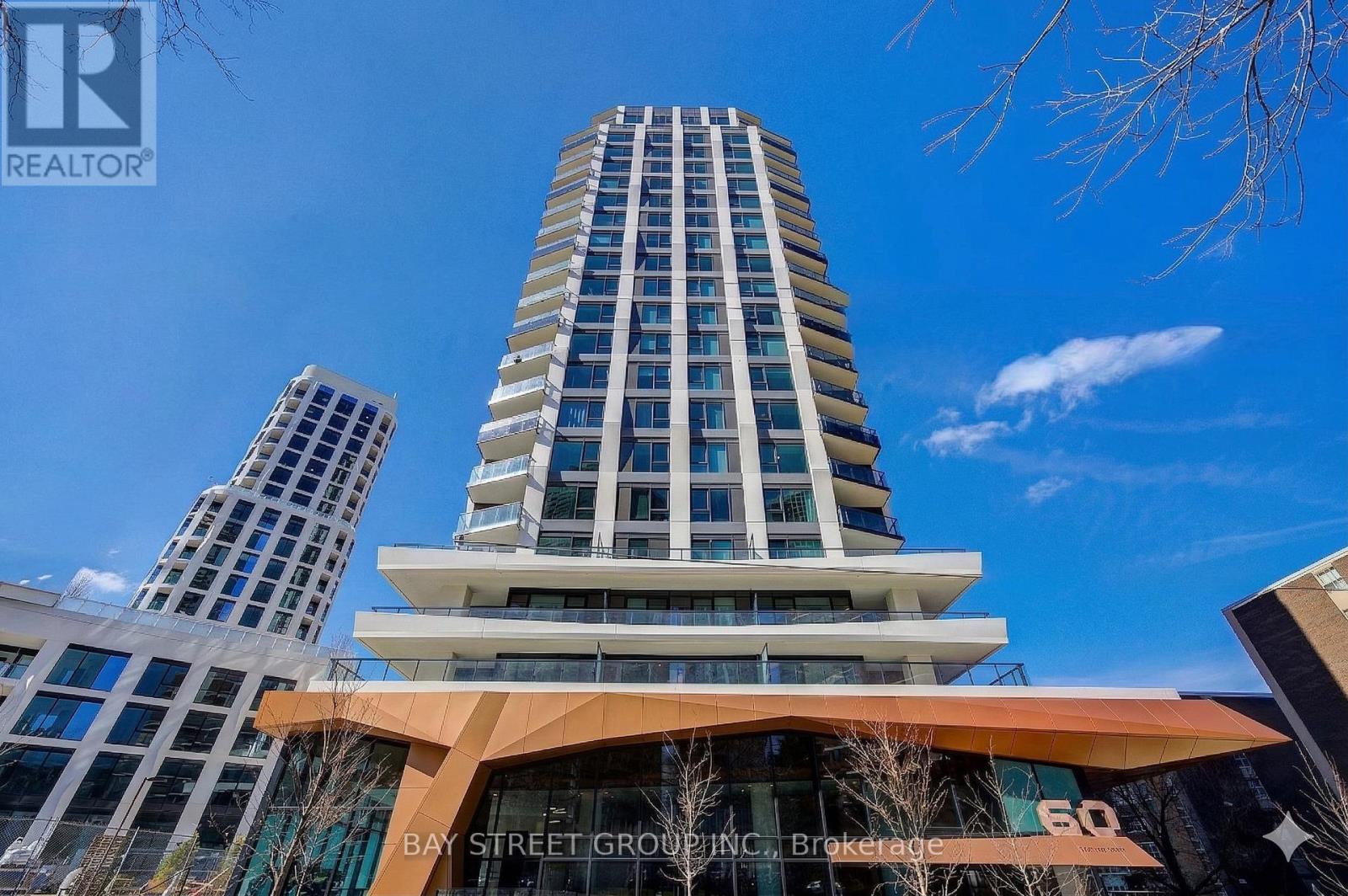 A tall building with a curved entrance and the words "Bay Street Group" on it.
