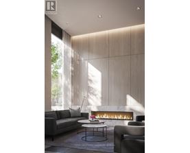A modern living room with a fireplace and a grey sofa.