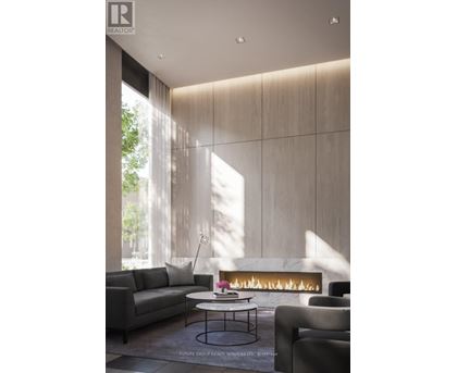 A modern living room with a fireplace and a grey sofa.