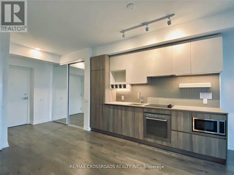 A modern kitchen with wooden cabinets and stainless steel appliances.