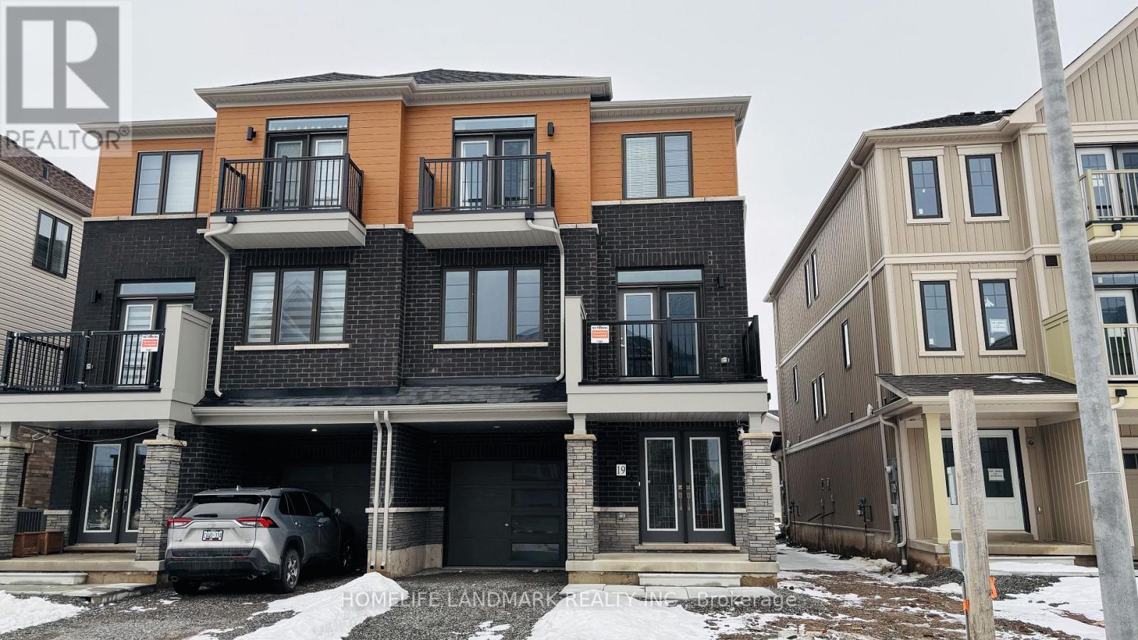 A modern two-story house with a car parked in front.