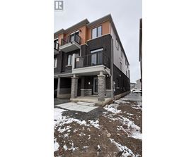 A building with a balcony and a door is in front of a wall.