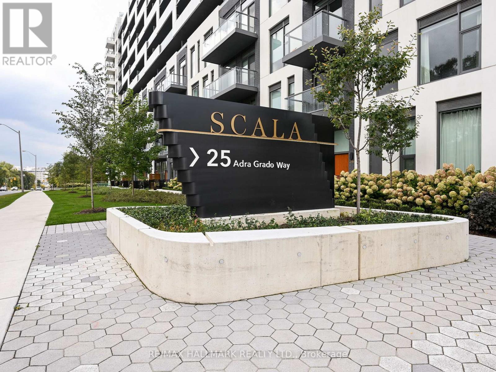 A sign for SCIALA is displayed in front of a building.