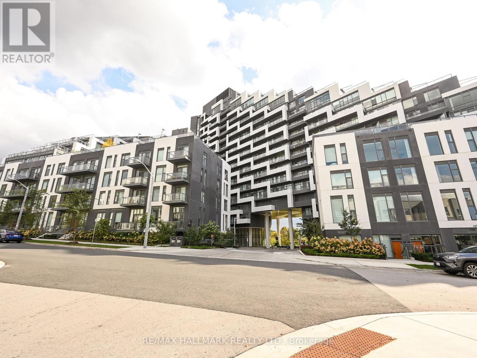 A modern apartment complex with multiple buildings and balconies.