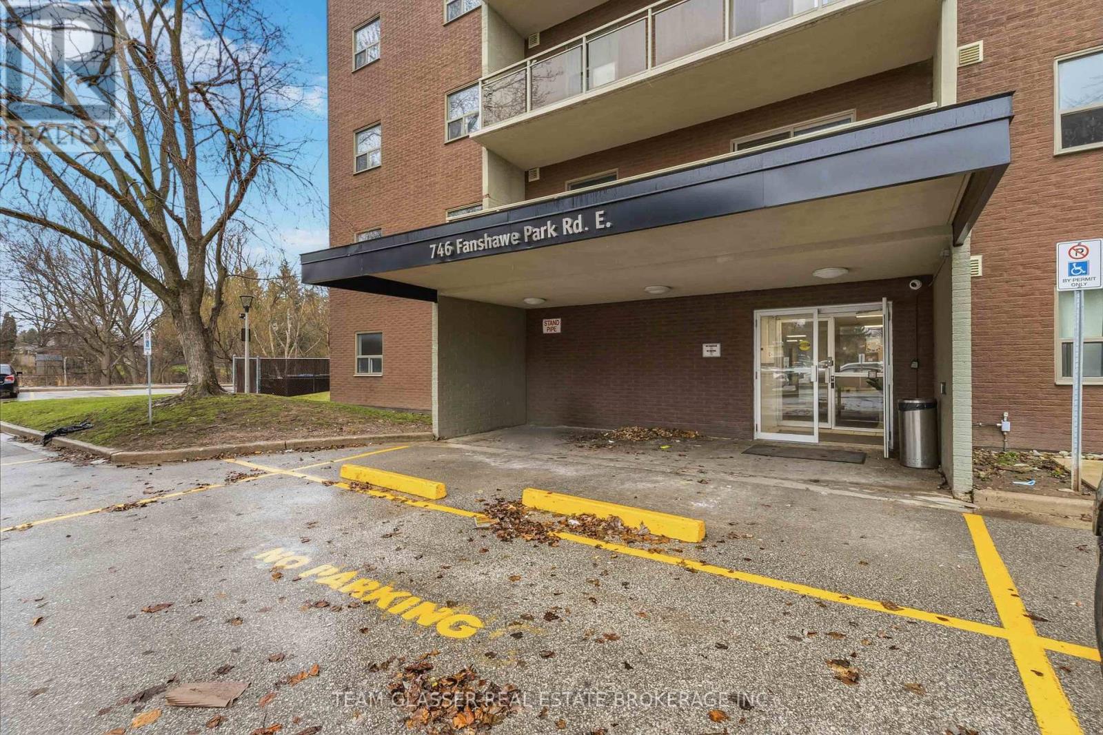 A parking lot in front of a building with the sign 746 Fairfax Park Rd. E.