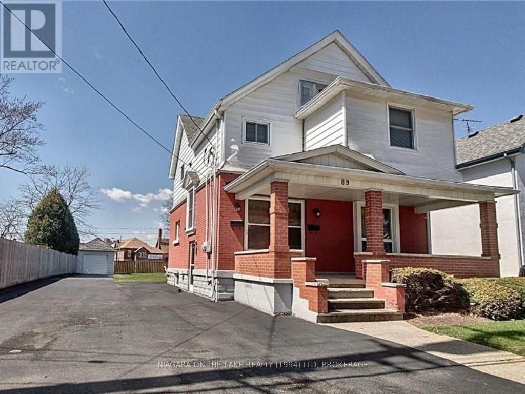 A two-story house with a red front door and white trim.