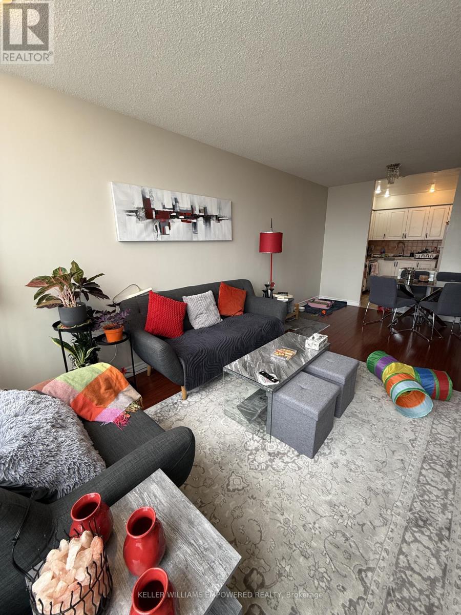 A bedroom with a bed, nightstand, and television.