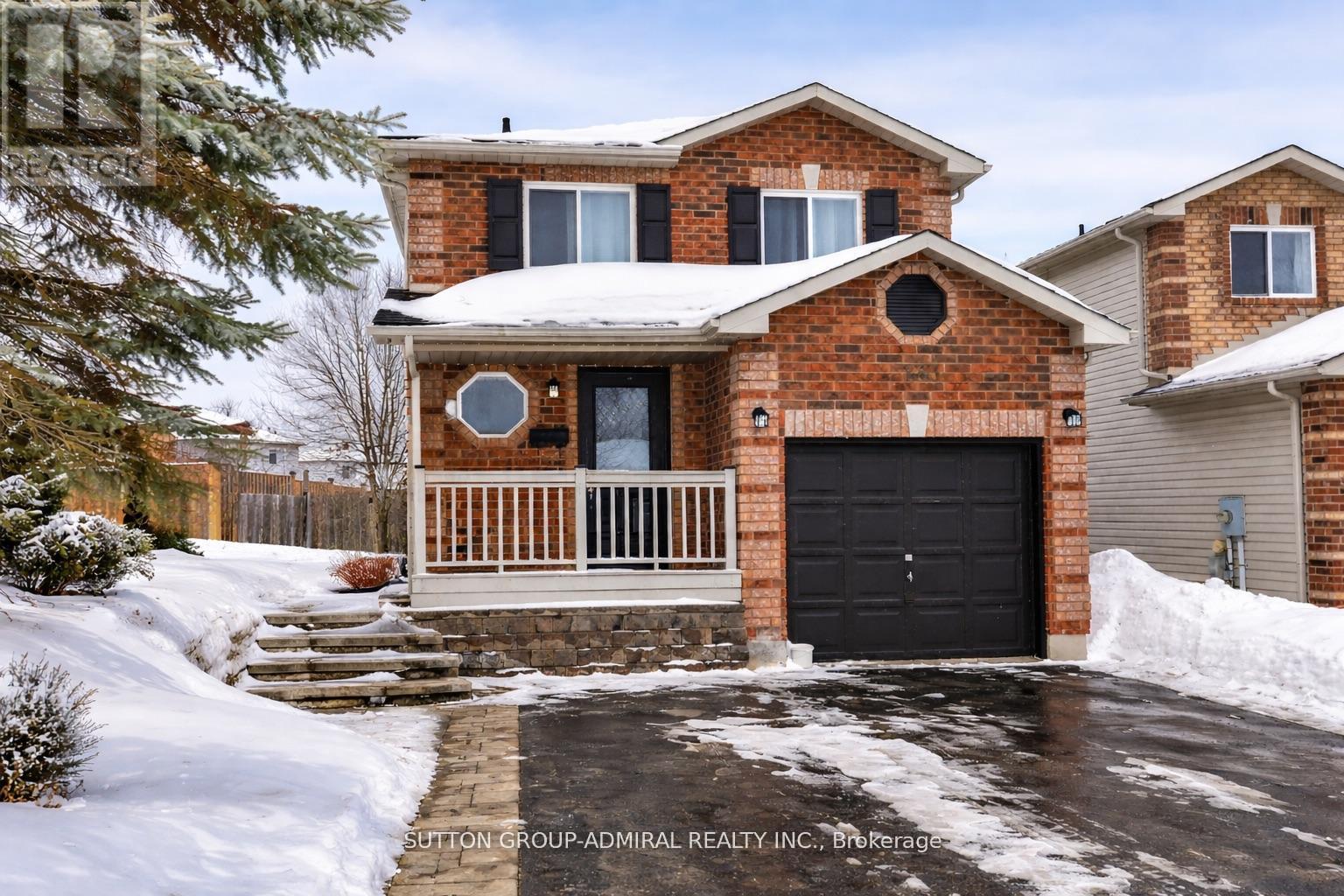 A house with a snow-covered front yard.