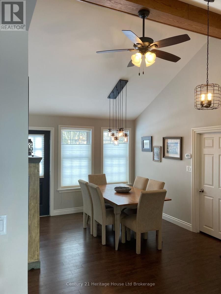 A dining room with a table and chairs.