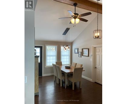 A dining room with a table and chairs.