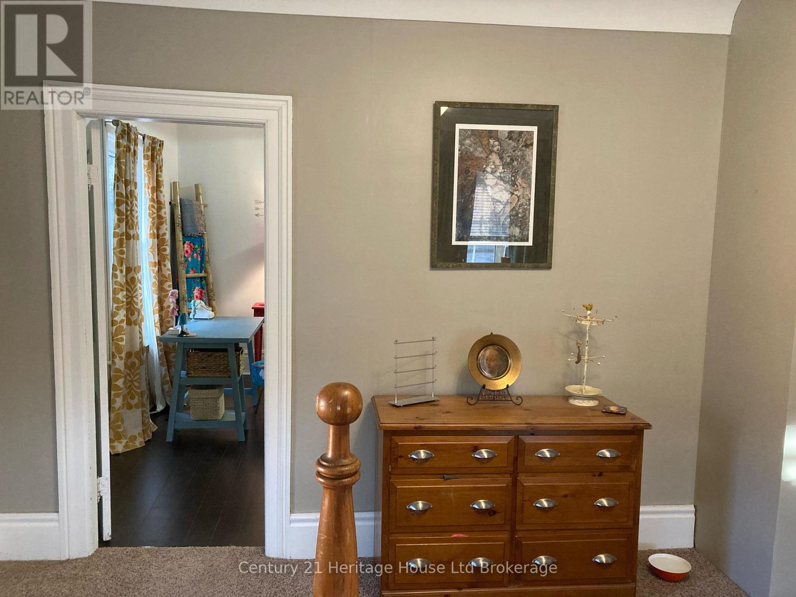 A bedroom with a dresser and a mirror.