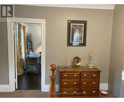 A bedroom with a dresser and a mirror.