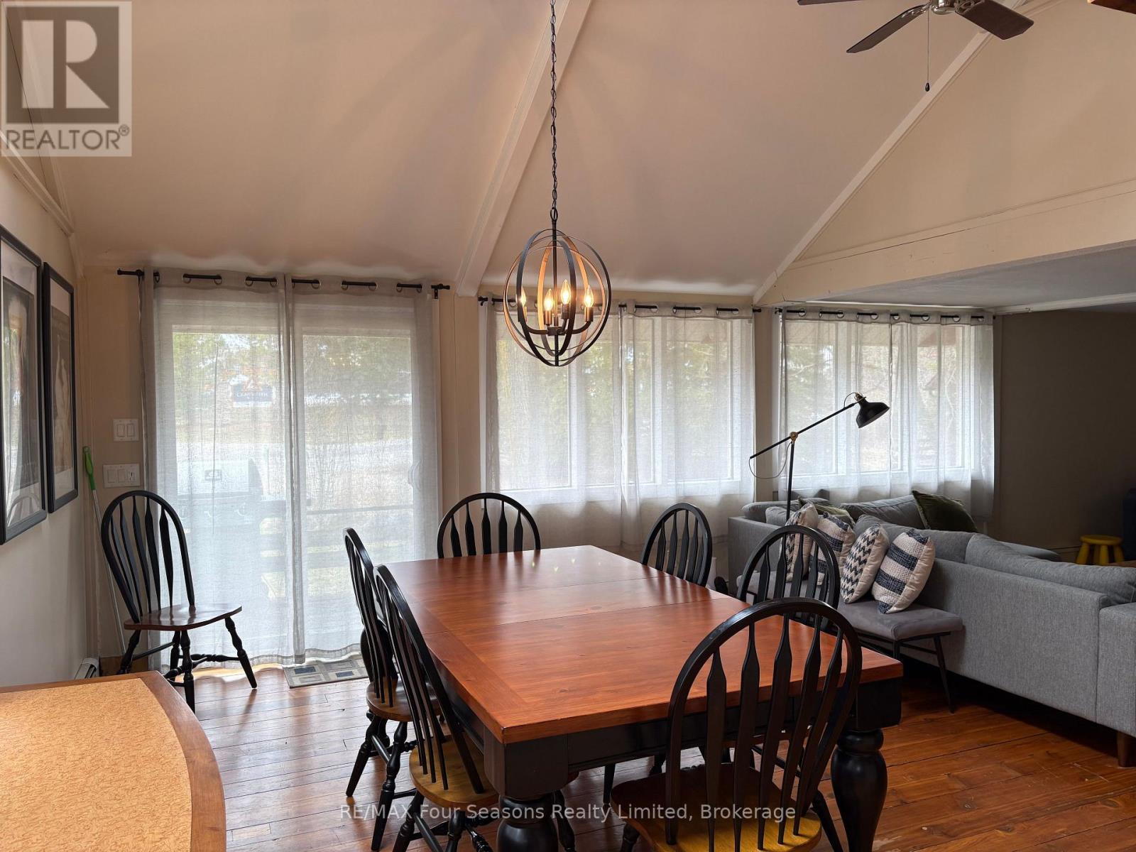 A dining room with a wooden table and chairs.