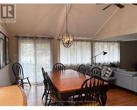 A dining room with a wooden table and chairs.