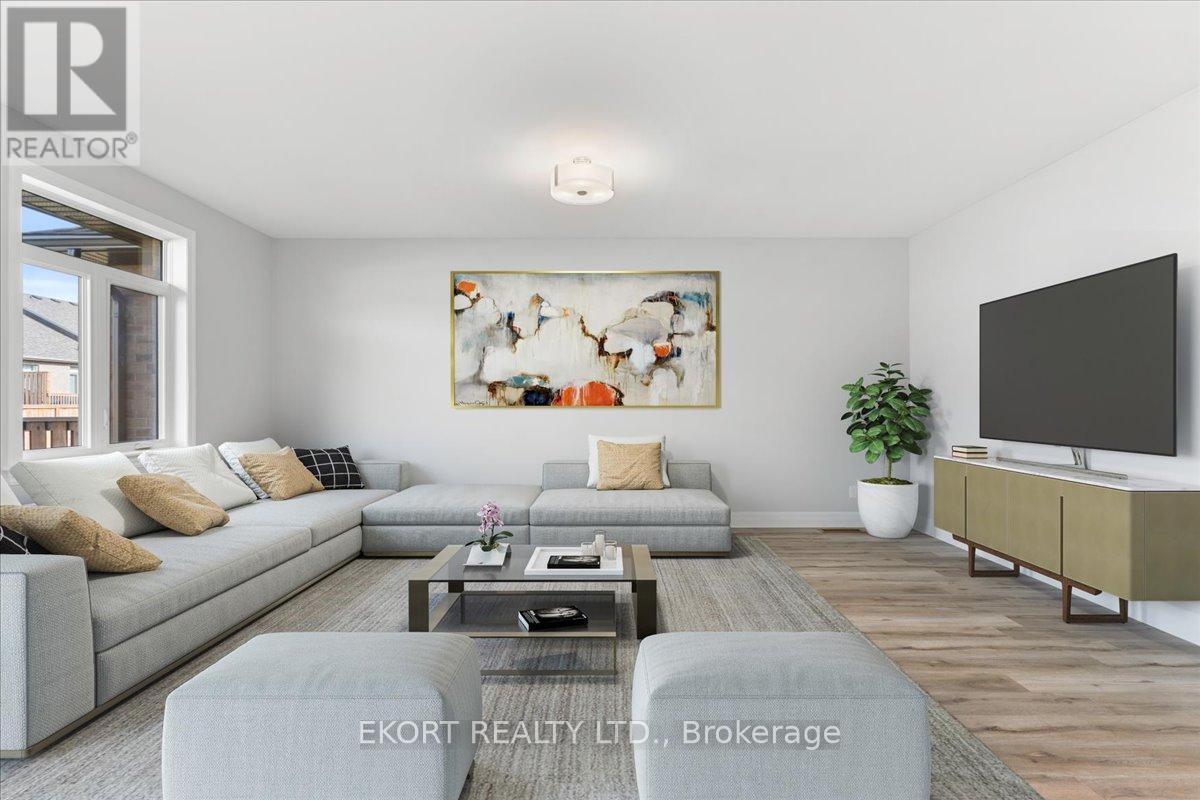 A living room with a grey sofa, a coffee table, a television, and a painting on the wall.