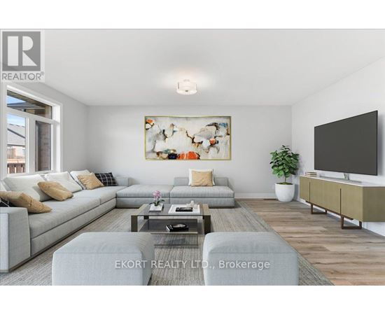 A living room with a grey sofa, a coffee table, a television, and a painting on the wall.