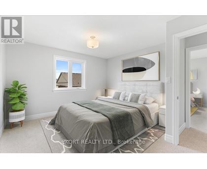 A bedroom with a large bed and a window.