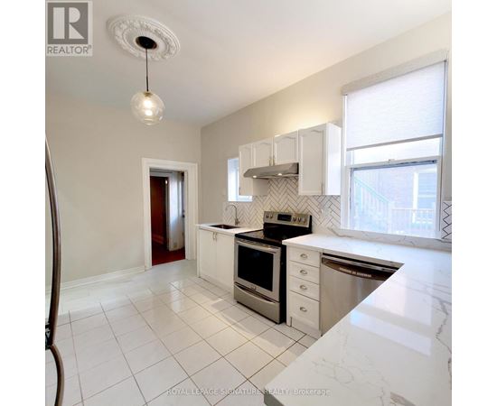 A kitchen with white cabinets and appliances.