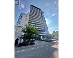 A tall building with a sign that says "HOME RUN REALTY INC., Brokerage" in front of it.