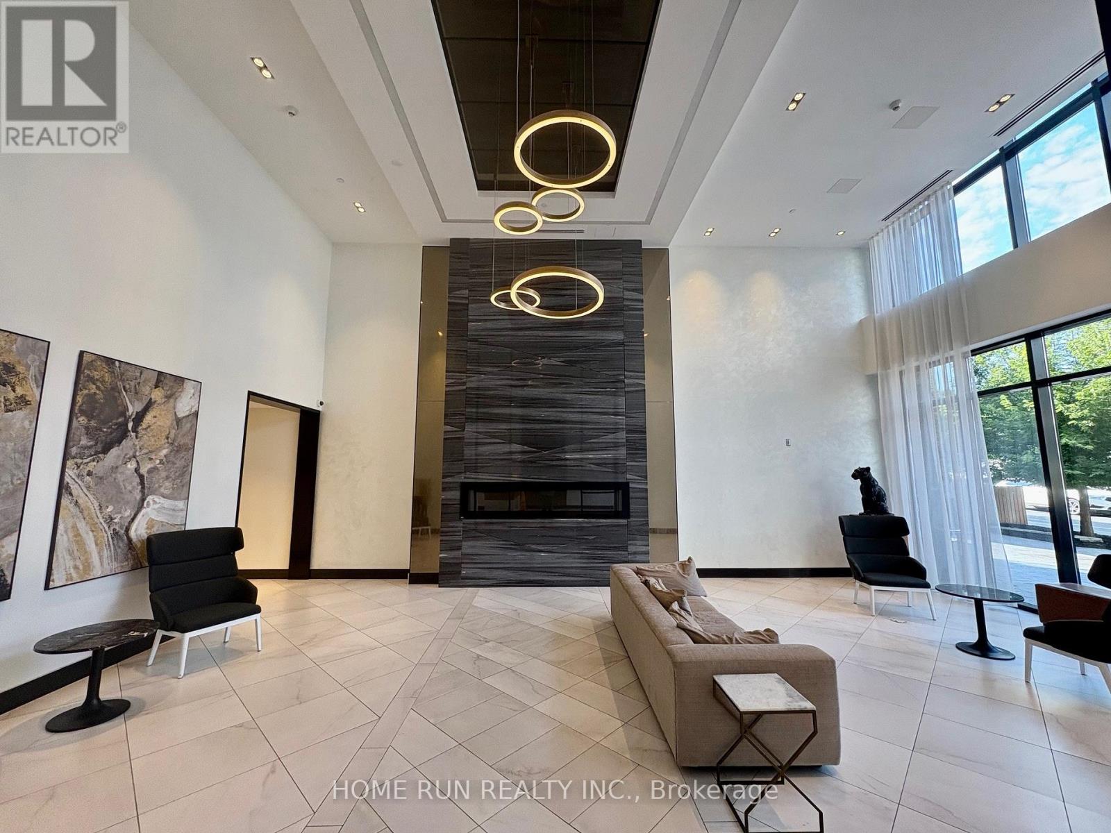 A modern living room with a fireplace and a large painting on the wall.