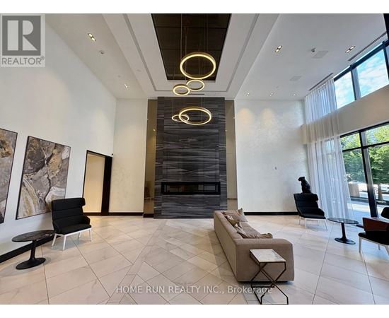 A modern living room with a fireplace and a large painting on the wall.