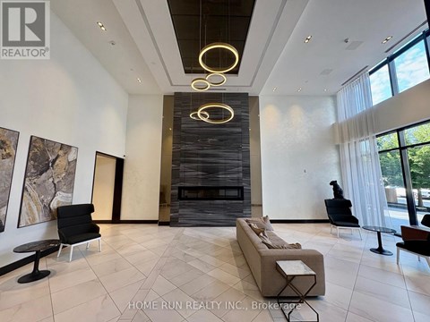 A modern living room with a fireplace and a large painting on the wall.
