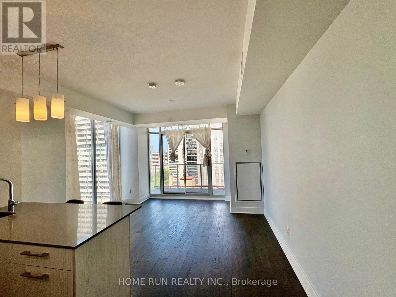 A kitchen with a sink and a window with blinds.