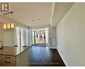 A kitchen with a sink and a window with blinds.