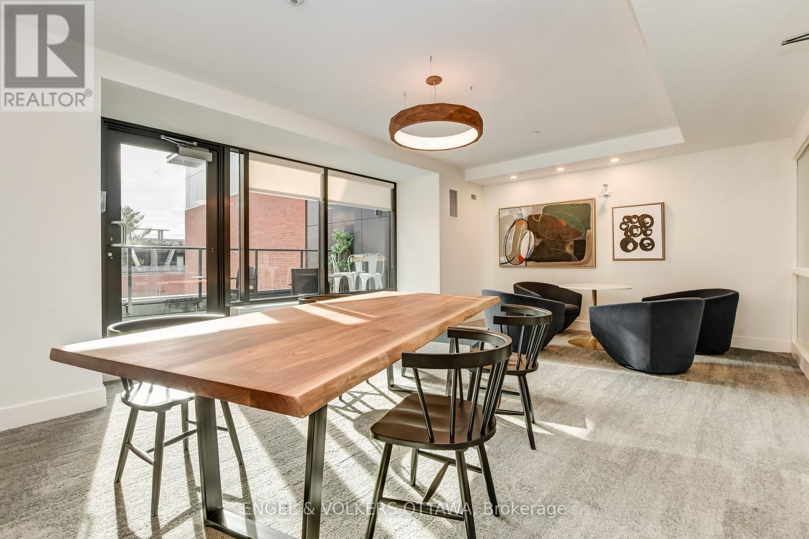 A modern dining room with a wooden table and chairs.
