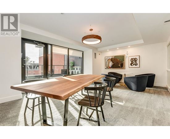 A modern dining room with a wooden table and chairs.