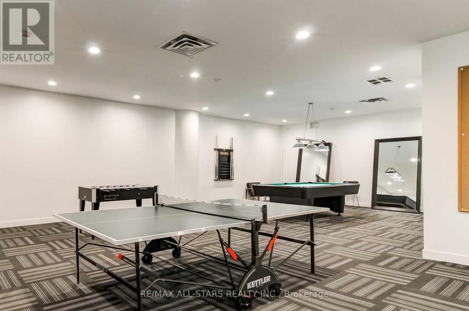 A room with a pool table and a billiard table.