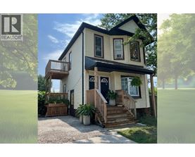 A two-story house with a balcony on the upper floor.