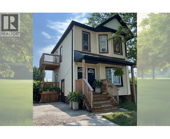 A two-story house with a balcony on the upper floor.