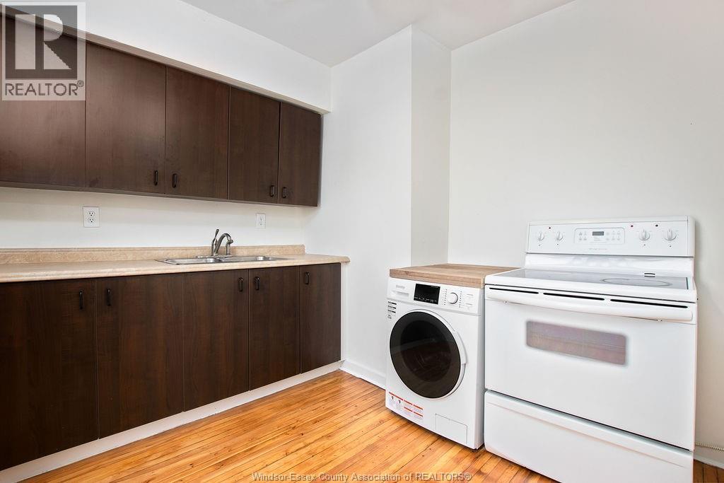 A kitchen with a washer and dryer in it.