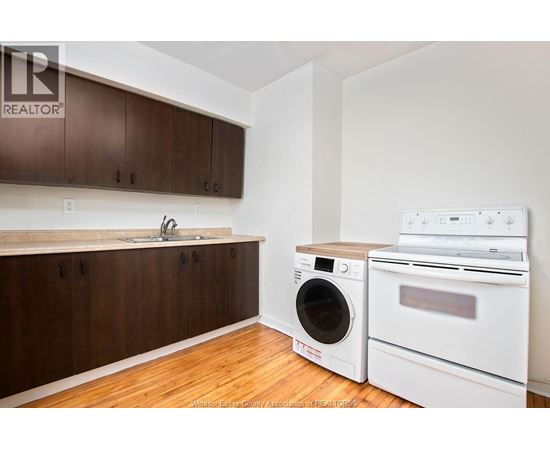 A kitchen with a washer and dryer in it.