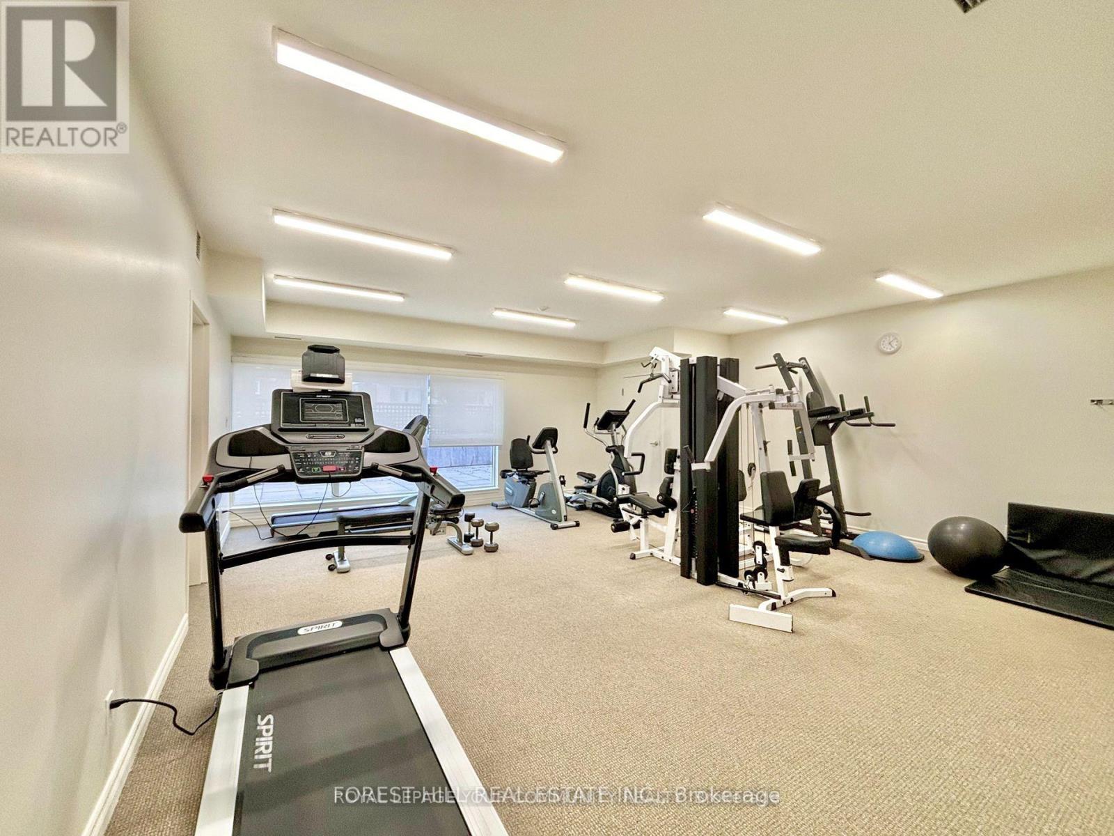 A home gym with a treadmill, weights, and exercise equipment.