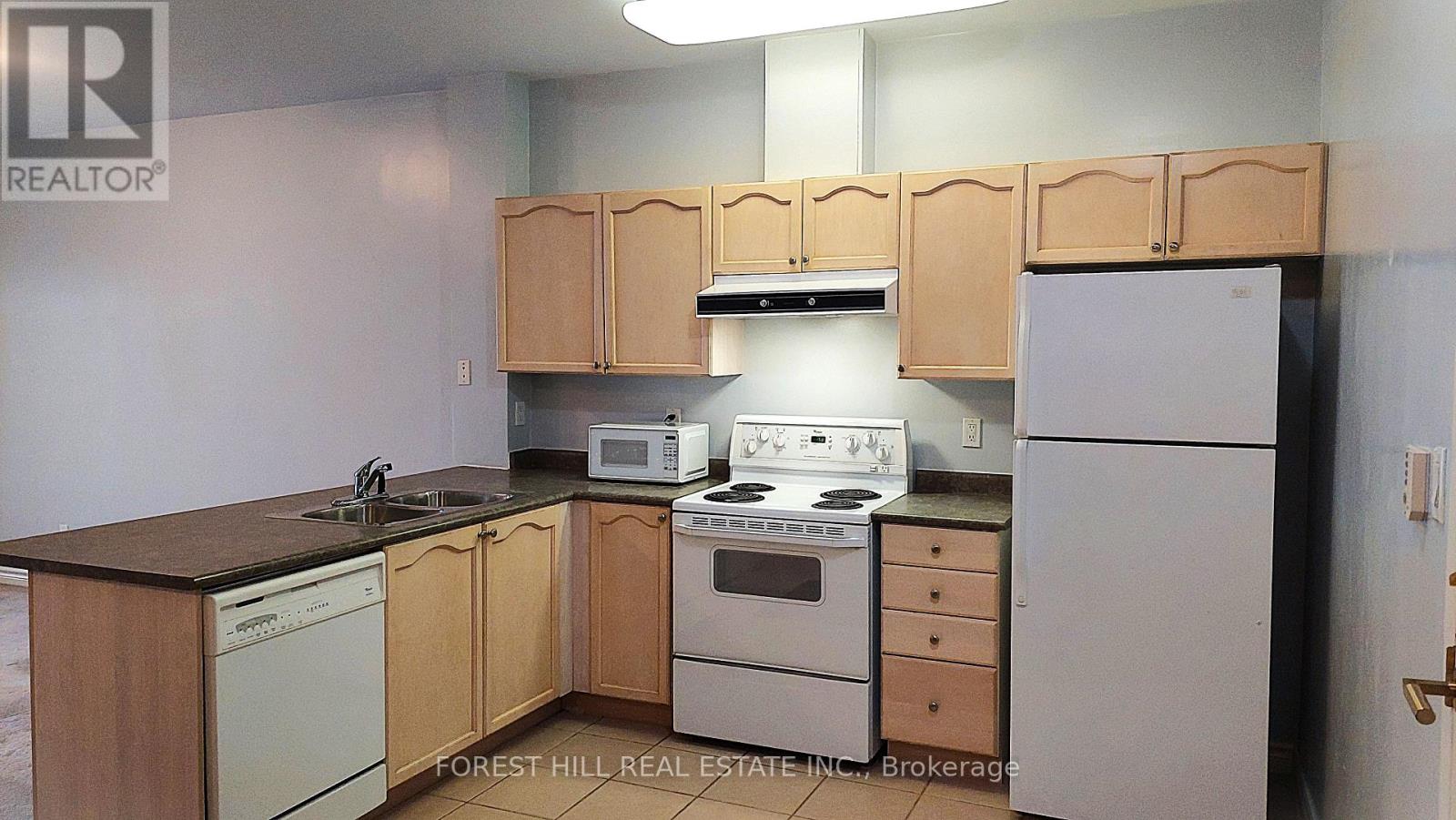 A kitchen with wooden cabinets and appliances.