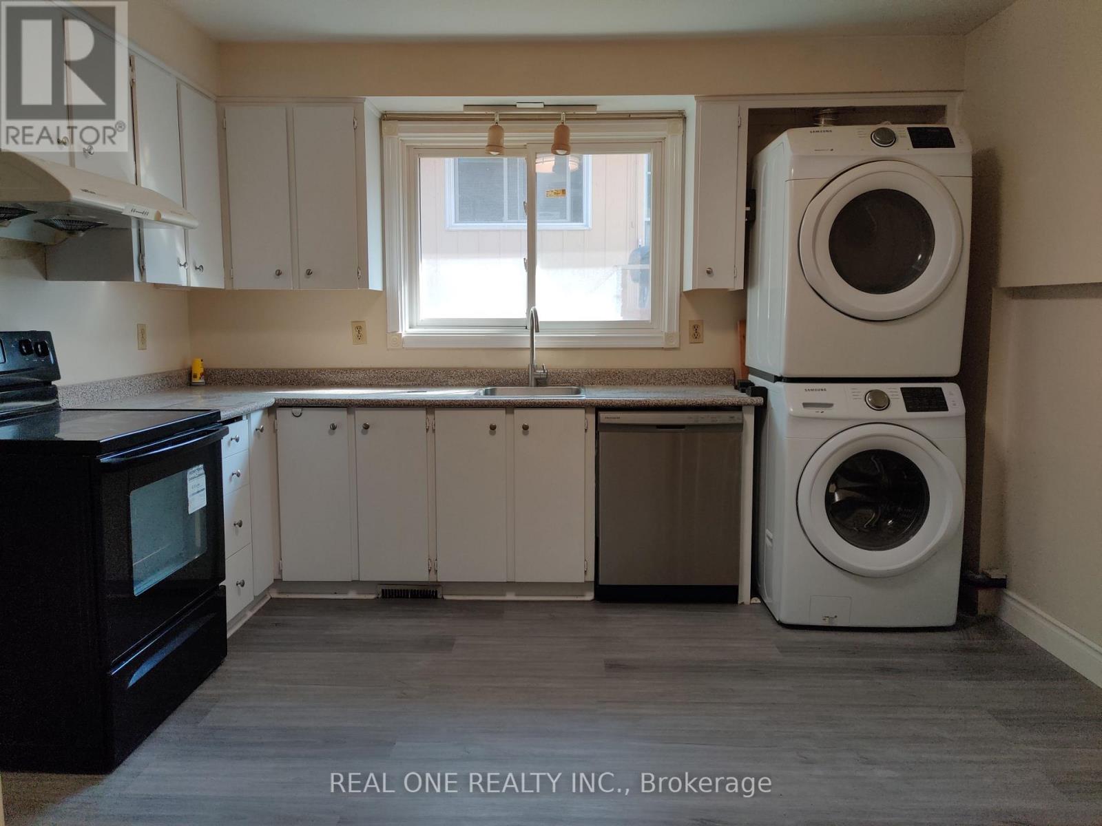 A laundry room with a washer and dryer stacked on top of each other.
