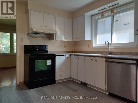 A kitchen with white cabinets and a black oven.