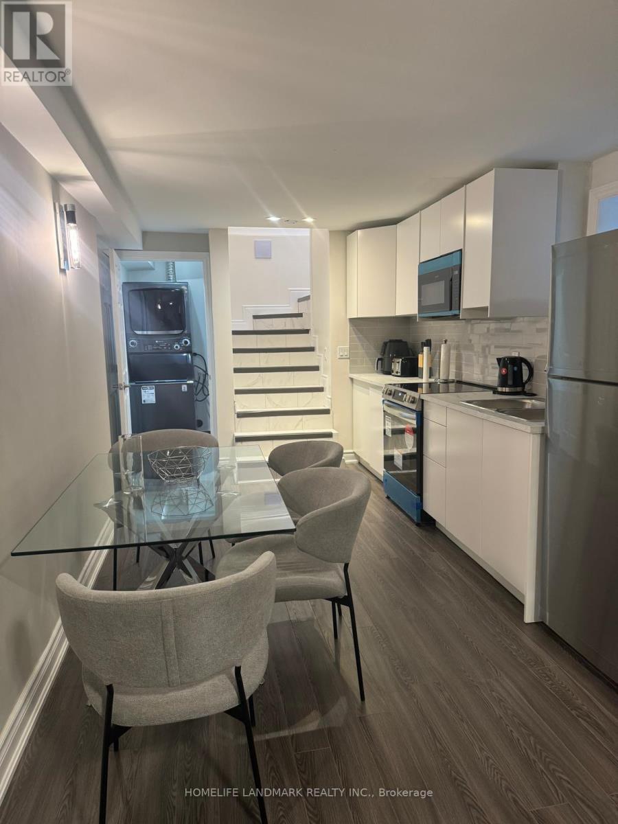 A modern kitchen with a glass table and chairs.