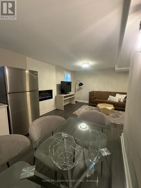 A modern living room with a glass table and a television.