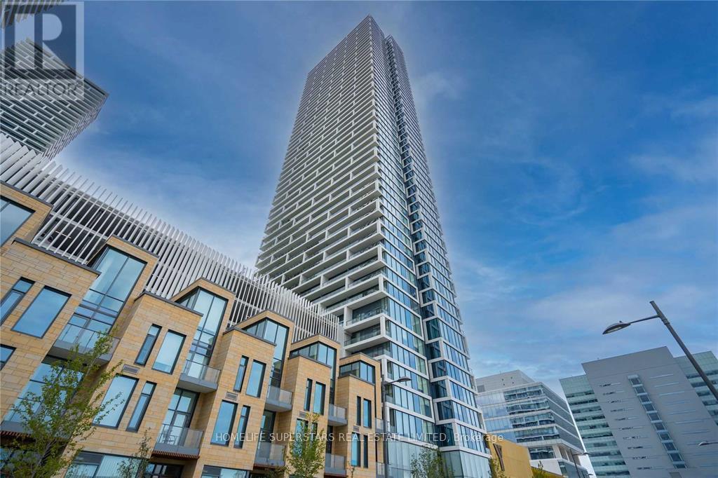 A modern building with a glass facade stands tall in the city skyline.