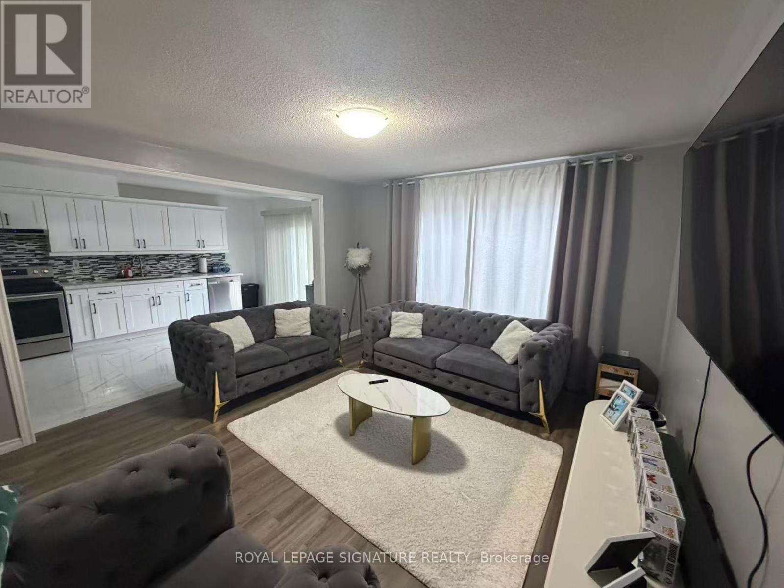 A living room with a grey couch and a coffee table.