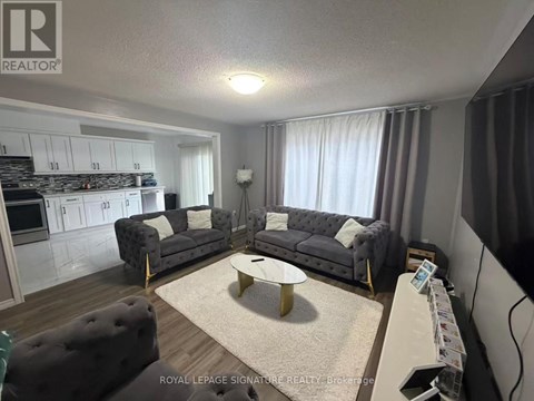 A living room with a grey couch and a coffee table.