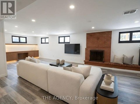 A living room with a white couch and a fireplace.