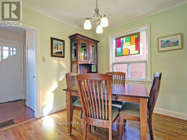 A dining room with a wooden table and chairs.
